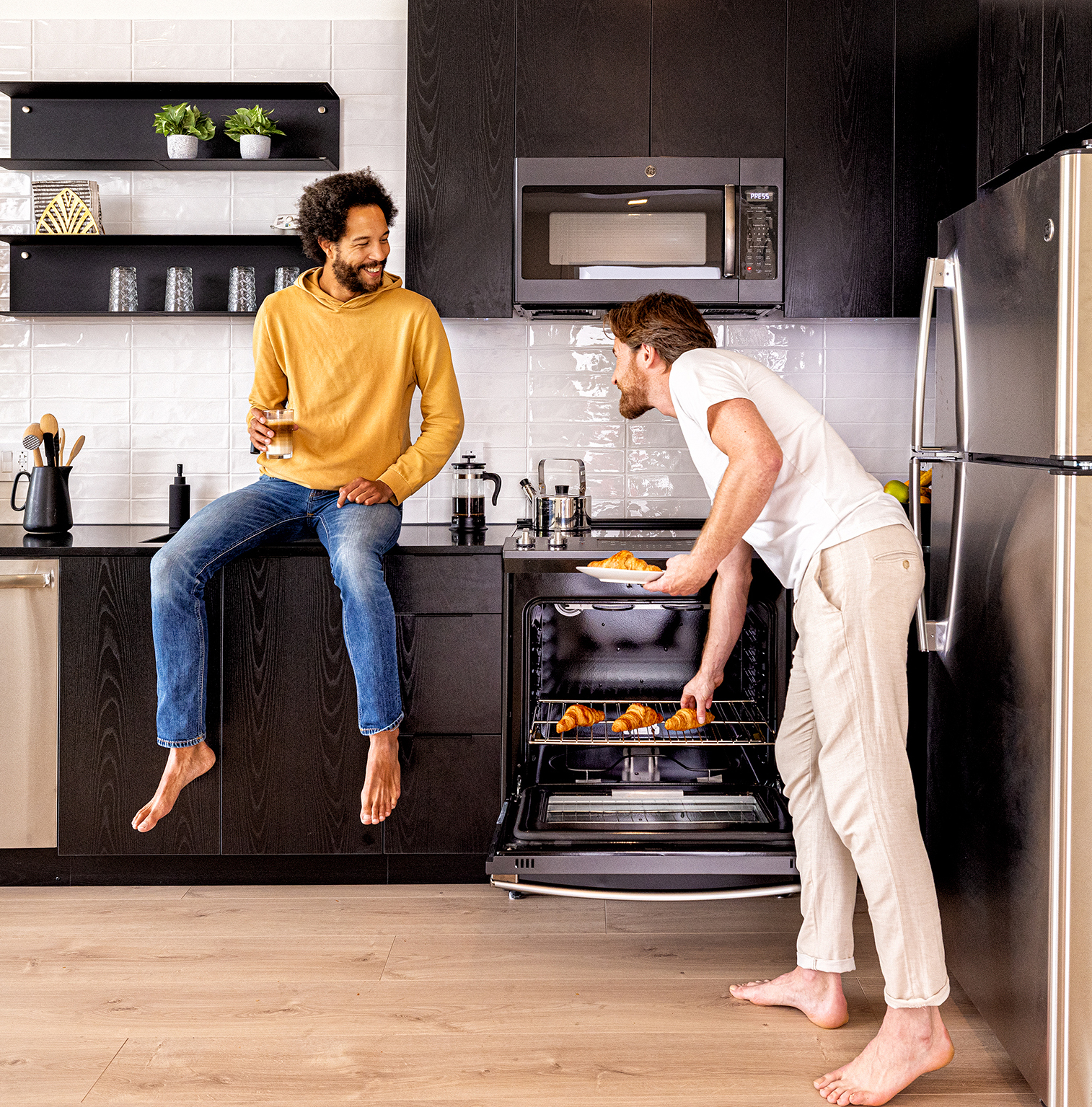 Men making breakfast in their kitchen in a modular built house
